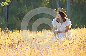 A girl in a beautiful grass flower field