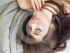 Girl with beautiful hair lying on the bed. Skin care concept