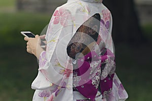 Girl in a beautiful kimono with a smartphone