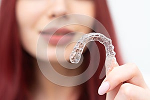 Girl with a beautiful smile shows a transparent mouth guard