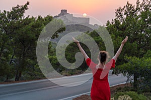 Girl and beautiful sunset near the castle