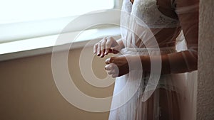 Girl in a beautiful white peignoir at the window