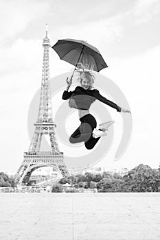Girl with beauty look at eiffel tower. Woman jump with fashion umbrella. Parisian isolated on white background. Happy