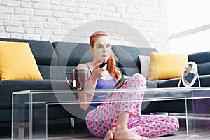 Girl With Beauty Mask Reading And Watching Television At Home