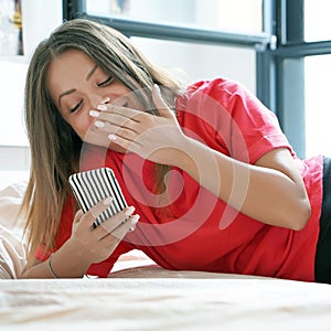 Girl in bed with a smartphone