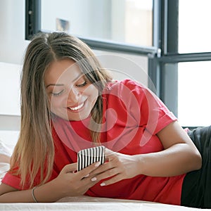 Girl in bed with a smartphone