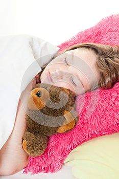 Girl in bed with stuffed bear