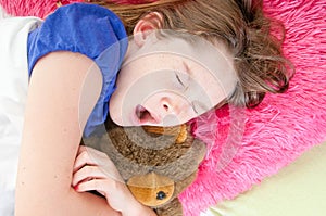 Girl in bed with stuffed bear