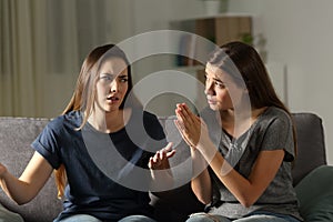 Girl begging forgive to her annoyed friend