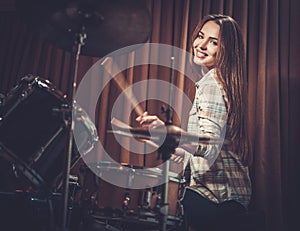 Girl behind drums on a rehearsal photo