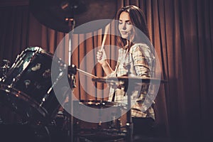 Girl behind drums on a rehearsal photo