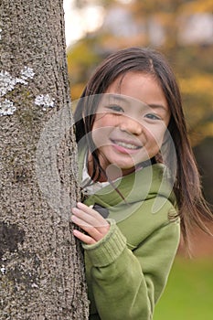 Girl behind the tree