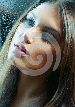 Girl behind the Wet Glass