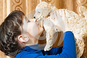 Girl with a beige puppy