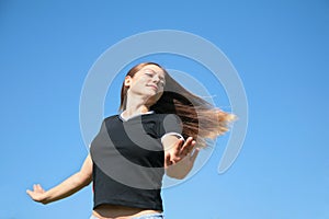 Girl with being fluttered hair on sky