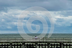 Girl on a bench near the South Beach Promenade in Aberystwyth, Wales