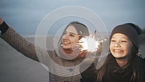 A girl with Bengal lights is having fun. A party on the beach with Bengal fire