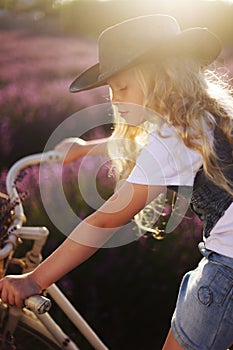 Girl on bicicle lavender photo