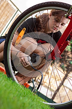 Girl and bicycle with air compressor