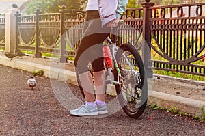 Girl with a bicycle on the embankment