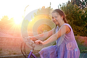 Girl in a bicycle outdoors