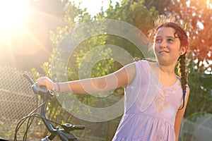 Girl in a bicycle outdoors