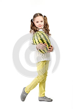 Girl with big toy watermelon on a white background.