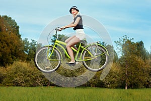 Girl on bike flies.