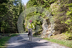 Girl on bike in forest at Ludrovska valley, Slovakia