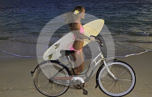 Girl with bike and surfboard