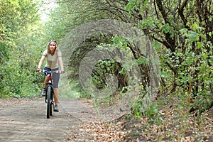 Girl biking in forest