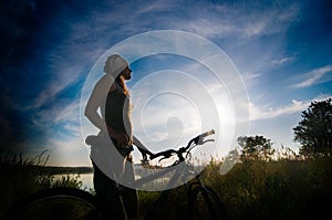 Girl biking at sunrise