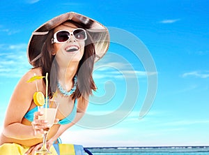 Girl in bikini drinking cocktail.