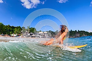 Girl in bikini has a fun on surf board