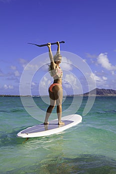 Girl in bikini on her paddle board