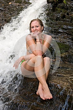 Girl in a bikini on rocks at a Mingo Falls.