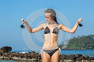 Girl in bikini with sea urchins