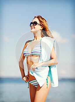 Girl in bikini and shades on the beach