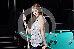 The girl at a billiard table