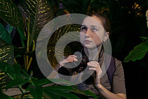 Girl with binoculars in the jungle