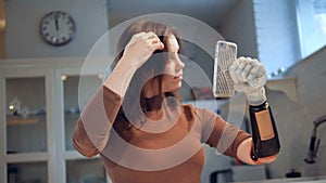 A girl with bionic hand uses a phone, close up.