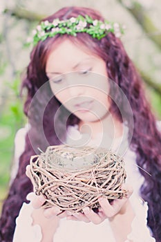 Girl with bird nest