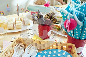 Girl birthday decorations. table setting from above with cakes, drinks and party gadgets.