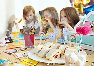 Girl birthday decorations. table setting with cakes, drinks and party gadgets.