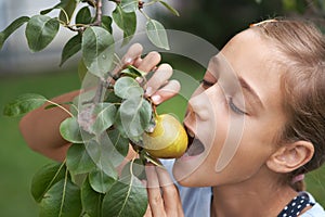 Girl biting a pear