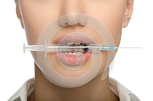 Girl biting a syringe photo