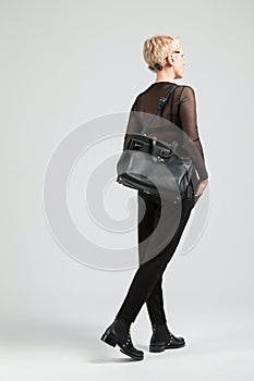 Girl with black bag and boots with thorns