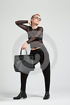 Girl with black bag and boots with thorns