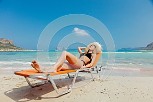 Girl in black bikini and with hat on Balos beach