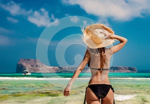Girl in black bikini and with hat on Balos beach